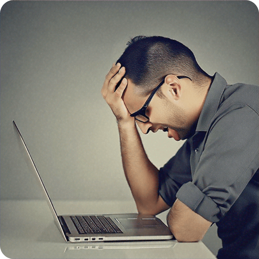 Frustrated person looking at laptop